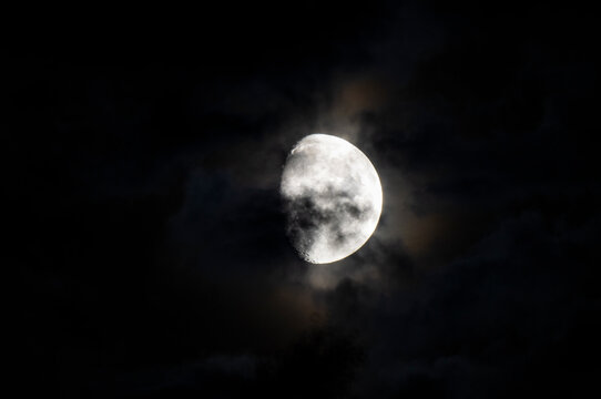 Clouds and spots on the moon. Moonlight in the black night sky © Payllik