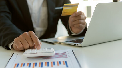 Businessman holding credit card for online shopping on computer Contactless people pay in restaurants for shopping. Smart payment concept, individual bank