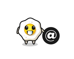 Cartoon Illustration of fried egg standing beside the At symbol