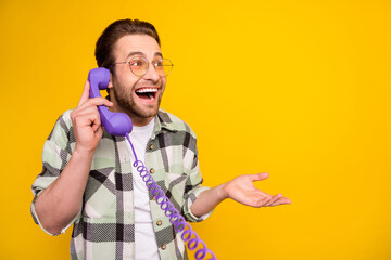 Profile side photo of young man happy positive smile speak call talk phone cord look empty space...
