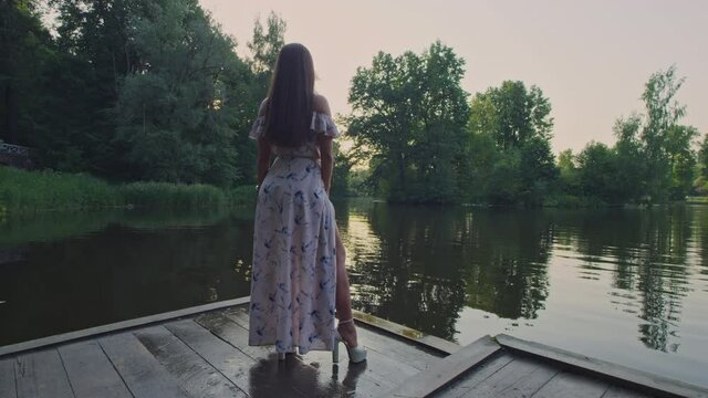 A model stands close to a river