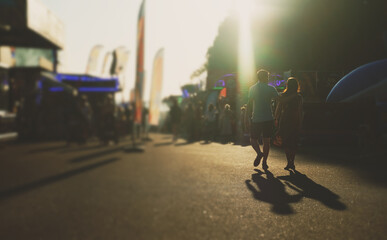 People walk down the street in summer. Blurred shot.