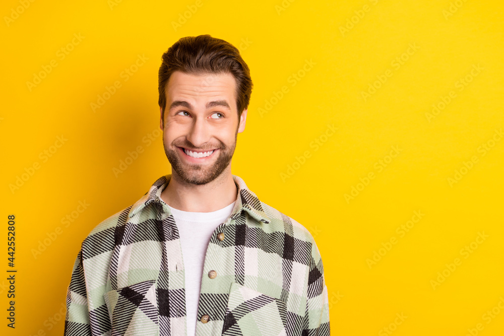 Sticker Photo of dreamy young happy cheerful man look empty space curious idea isolated on yellow color background