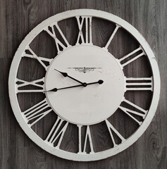 Old classic fashioned clock with Roman Numeral on wooden backgounds, home decoration wallpaper