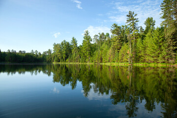 Beautiful small blue lake in northern Minnesota on a calm summer morning