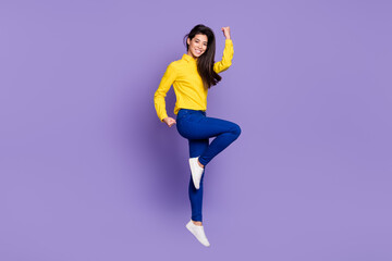 Fototapeta na wymiar Full body profile side photo of triumphant young woman raise fists win jump up air isolated on violet color background