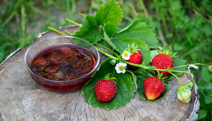 Strawberry jelly, jam on a wooden background, environmentally friendly product.
