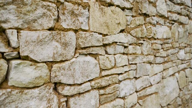 White stone masonry. Texture of a stone wall. Old castle stone wall texture background. Stone wall as a background or texture.