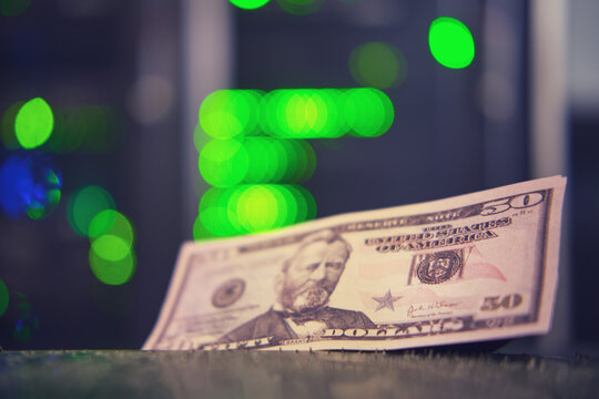 Money in us dollars on the background of computer equipment in a server room