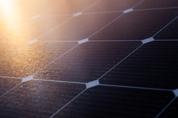 Solar panel close-up with the rays of the setting sun in the corner. - obrazy, fototapety, plakaty
