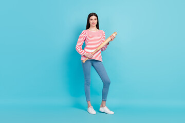 Full length body size view of attractive confident powerful girl holding basketball bat isolated over bright blue color background