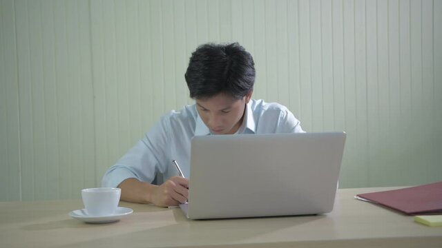 Business concept of 4k Resolution. An Asian man is delighted at his success at the office.