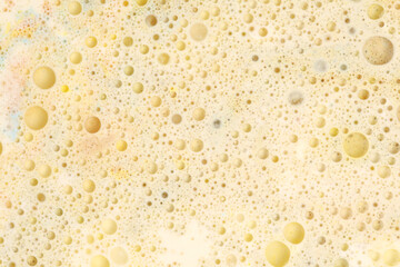 Macro Gold and bronze bubble drops. Abstract flow color blots on light horizontal background.