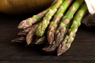 Green asparagus closeup on wooden background