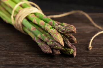 A bunch of a green asparagus on wooden background