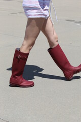 Girl wearing red rubber boots at pool