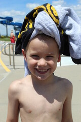 Young boy with towel wrapped around head
