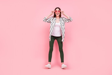 Obraz na płótnie Canvas Full length photo of young excited girl happy positive smile have fun sunglass isolated over pastel color background