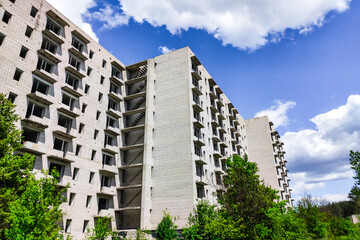 Fototapeta premium Abandoned high-rise buildings, city. Clean quarts and buildings without windows or doors.