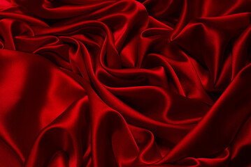 Rich and luxury red silk fabric texture background.