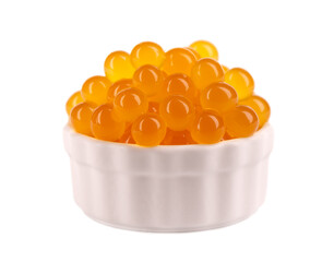 Red tapioca pearls for bubble tea isolated on white background. Tapioca pearls in white ceramic...