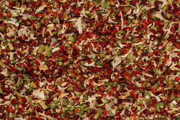 Seasoning for soup, dried vegetables slices background.