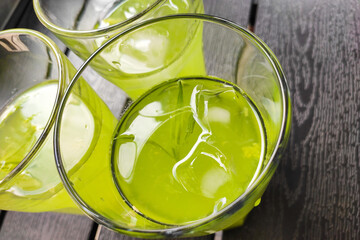 Three glasses of cold lemonade tarragon kiwi lime.