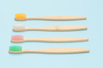 Bamboo toothbrush on a blue background. Top view.