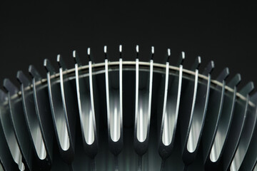 LED phytolamp for growing seedlings. Aluminum cooling fins, close-up, black background.