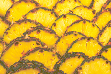 Pineapple juicy yellow slices background. Top view.