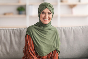 Portrait Of Smiling Senior Muslim Lady Wearing Hijab At Home