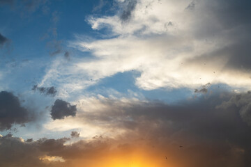 Naklejka na ściany i meble Blue sunset sky with dramatic clouds. Sky background after sunset.