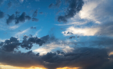 Naklejka na ściany i meble Blue sunset sky with dramatic clouds. Sky background after sunset.