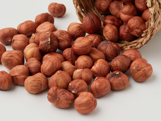 Close-up of hazelnut kernels on a white background, macro-detailed