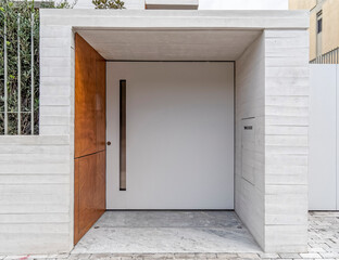 contemporary house front entrance white door by the sidewalk