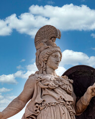 Fototapeta premium Athena ancient Greek goddess statue and blue sky with some white clouds