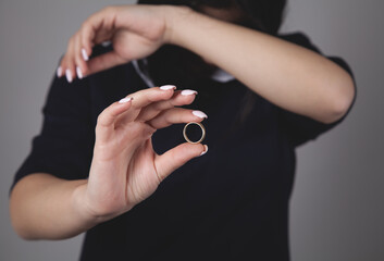 Taking off the wedding ring. Caucasian sad woman. Divorce concept.