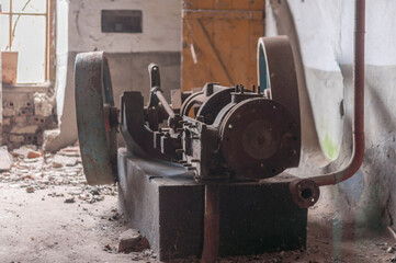 The steam engine in abandoned distillery next to the palace