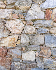rough various colored stone wall closeup, seamless natural background