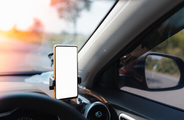selective focus of smartphone  device gadget with white screen mounted on phone holder in car for...