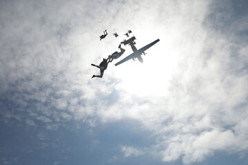 Fototapeta na wymiar Skydiving. Half-naked skydivers are falling in the sky.