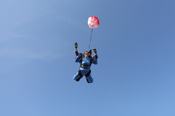 Obraz na płótnie Canvas Skydiving. Tandem jump. A parachute is deploying.