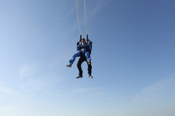Fototapeta na wymiar Skydiving. Tandem jump. A parachute is deploying.