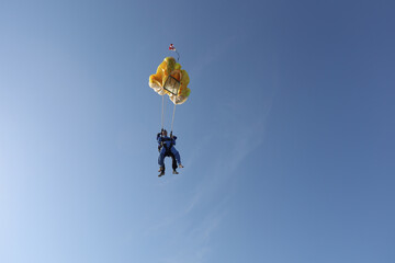 Skydiving. Tandem jump. A parachute is deploying.