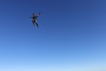 Naklejka na ściany i meble Skydiving. Solo girl is flying in the sky