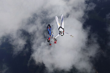 Formation skydiving. Skydivers just jumped out of a plame and falling into the sky.