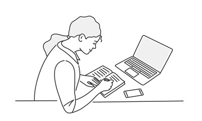 Young woman sitting behind work table and writing.