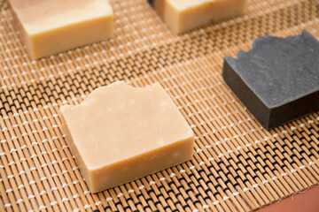 Top view of different hand made soap bars on bamboo mat 