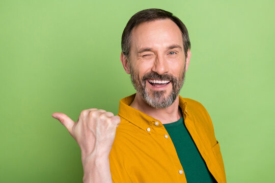 Profile Side Photo Of Mature Man Happy Positive Smile Wink Eye Point Thumb Empty Space Ad Suggest Isolated Over Green Color Background