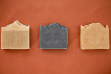 top view of hand made soap bar isolated on brown 